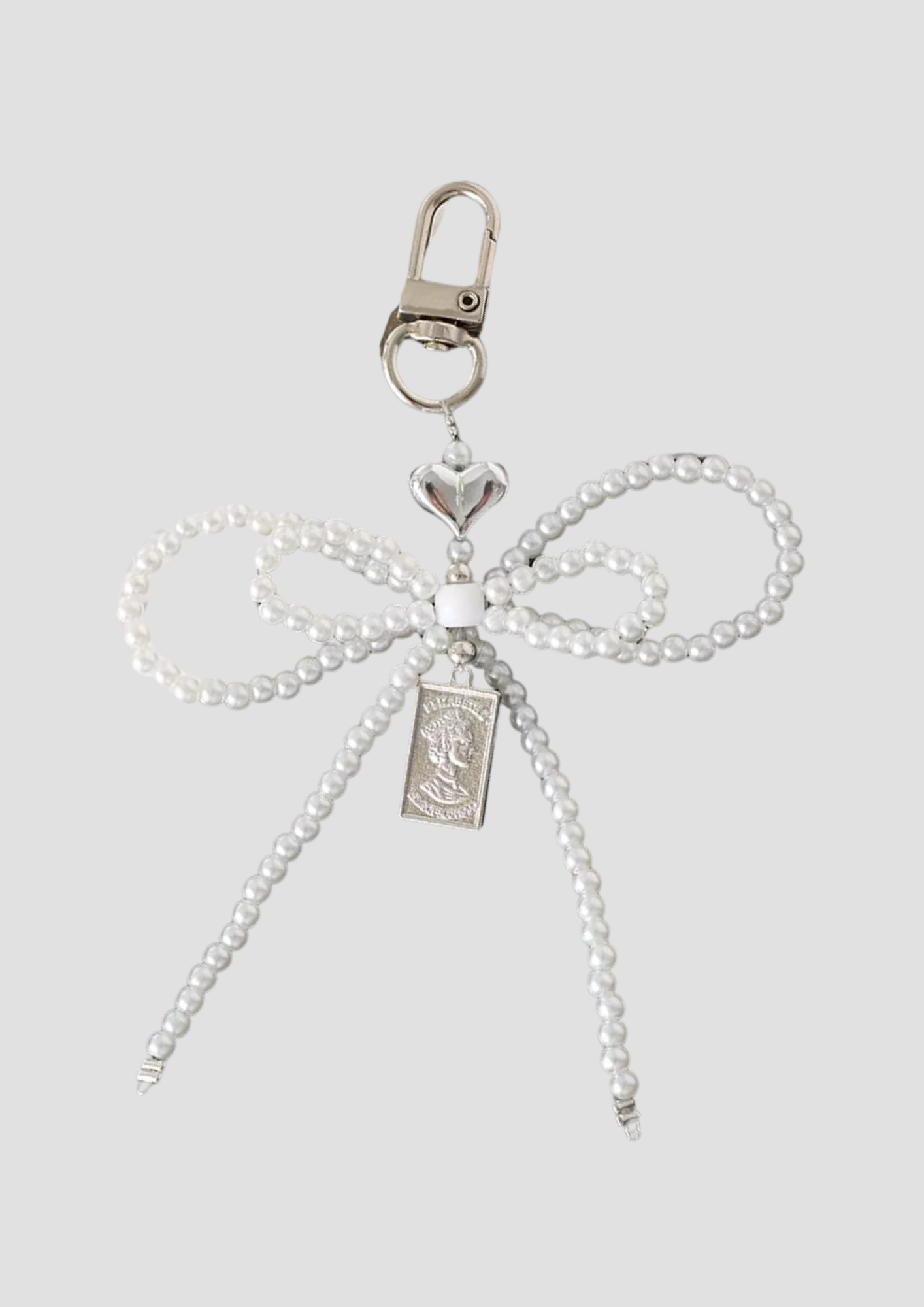 Pearl Tie charm – delicate bow charm with pearl detailing, elegant and feminine