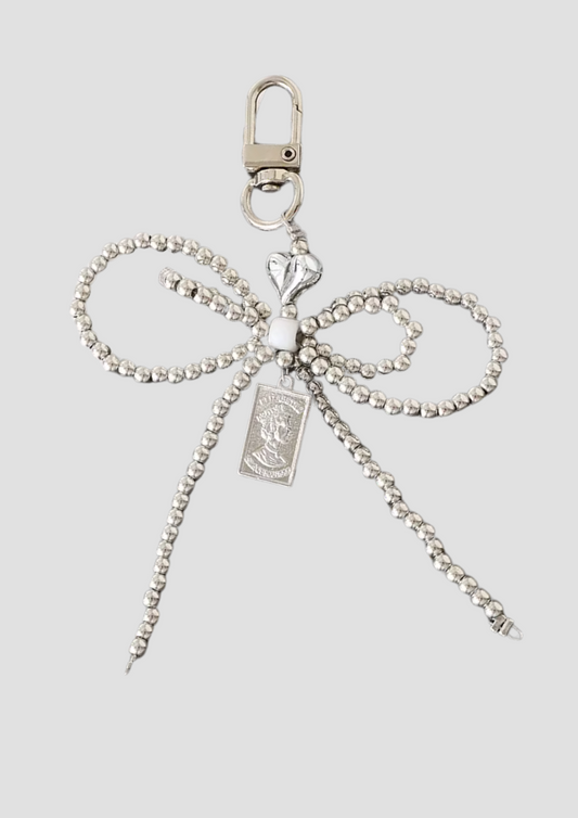 Pearl Tie charm – delicate bow charm with pearl detailing, elegant and feminine